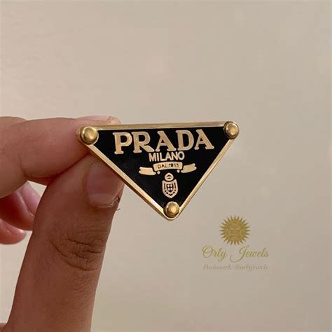 prada shuttle brooch|prada brooch.